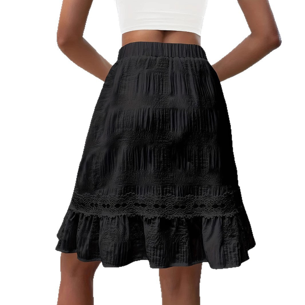 Black skirt with lace details worn by a person on a white background