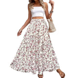 Woman wearing a white floral skirt and top with a woven bag indoors.