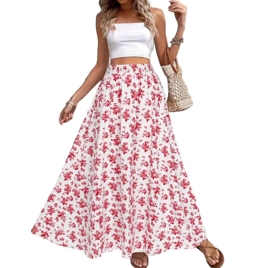 Woman wearing a white top and red floral skirt with a neutral background