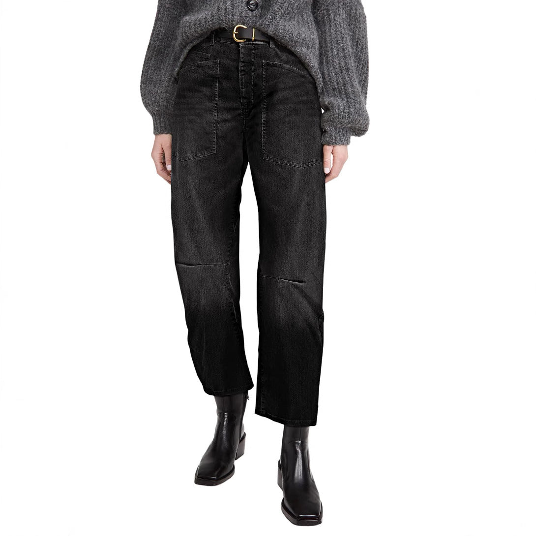 Person wearing black jeans and a gray sweater on a white background