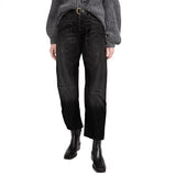 Person wearing black jeans and a gray sweater on a white background