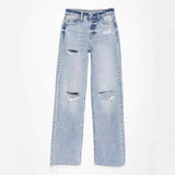 Light blue jeans with distressed details on a white background