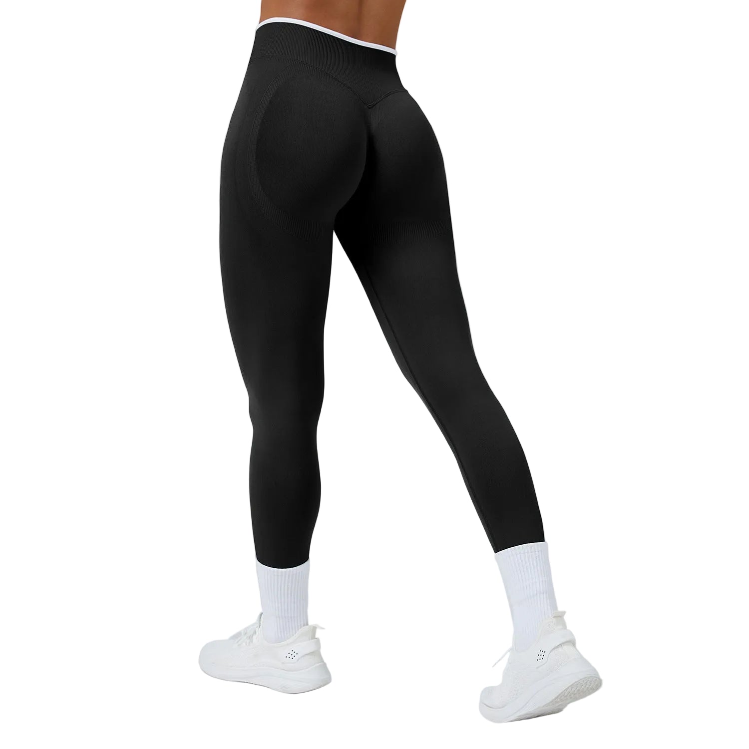 Person wearing black leggings and white sneakers on a gray background