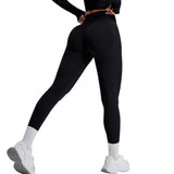 Person wearing black leggings and white sneakers on a light gray background