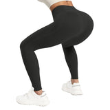 Person wearing black leggings and white sneakers on a plain background