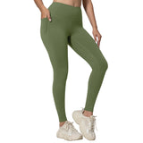 Person wearing green leggings and white sneakers on a light gray background