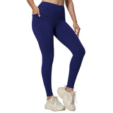 Person wearing blue leggings and white sneakers on a gray background