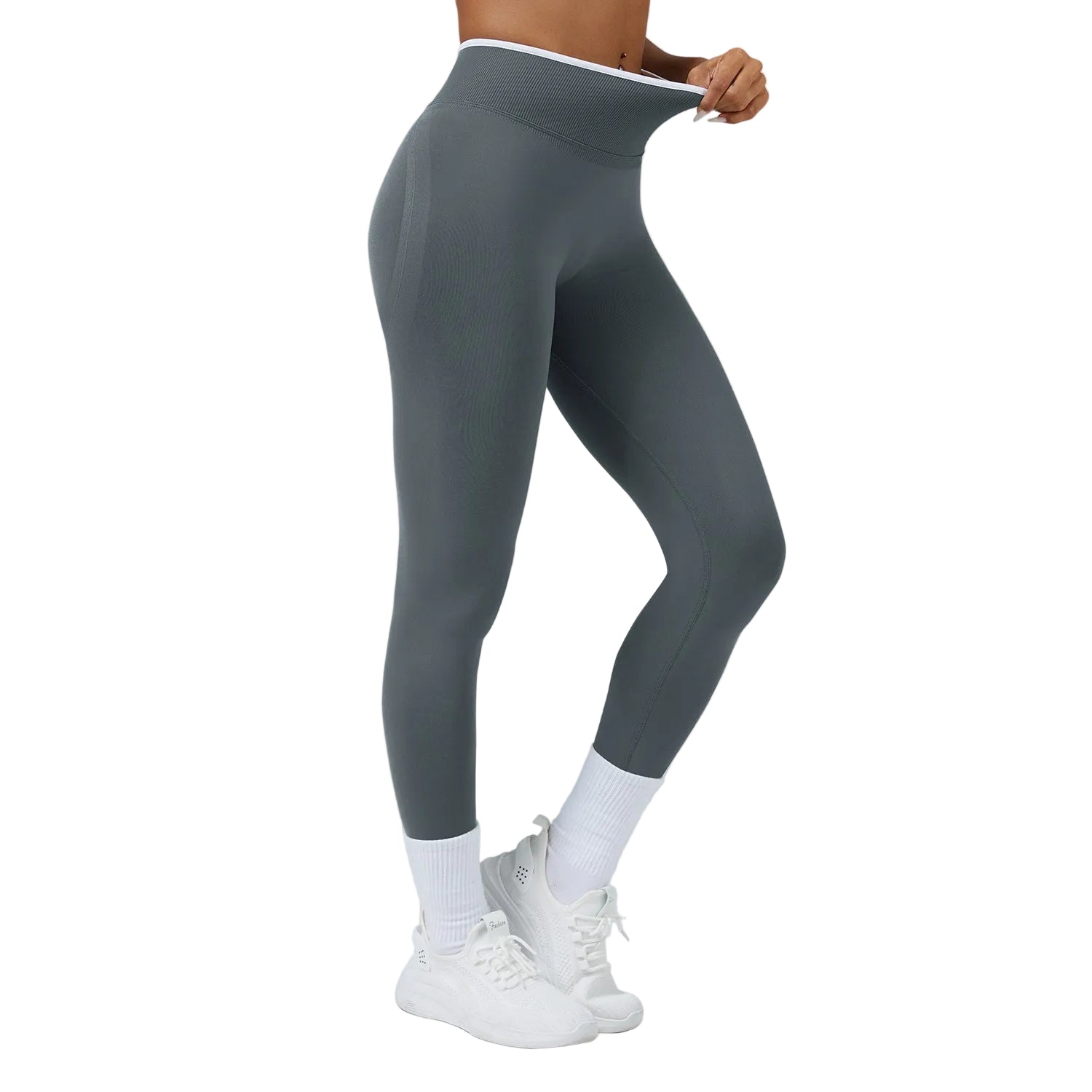 Person wearing gray leggings and white sneakers on a plain background