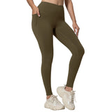 Person wearing olive green leggings and white sneakers on a light gray background