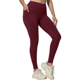 Person wearing olive green leggings and white sneakers on a light gray background
