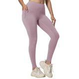 Person wearing pink leggings with a plain background