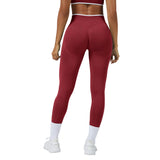 Person wearing red leggings and white top on a gray background