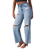 Person wearing ripped blue jeans on a gray background