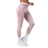 Pink leggings worn by a person on a gray background