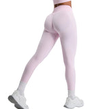 Pink leggings worn by a person on a light gray background