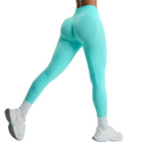 Teal leggings worn by a person on a light gray background