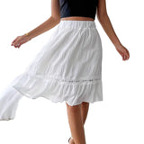White skirt with lace details worn by a person indoors.