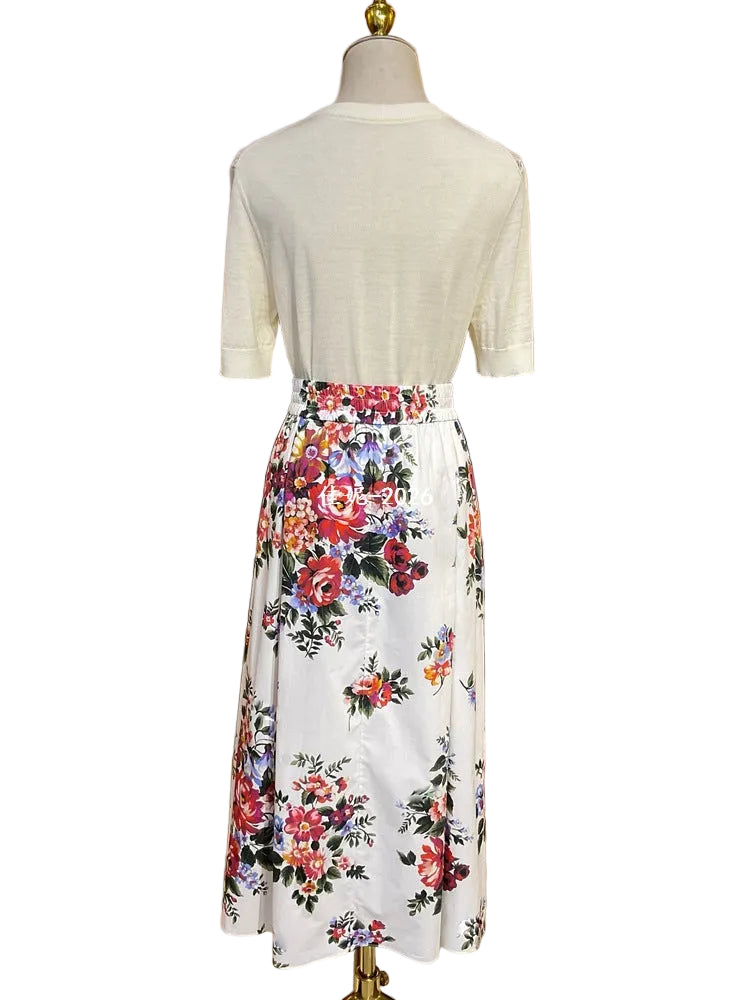 Mannequin wearing a white top and floral skirt with a blurred background