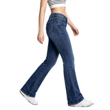 Person wearing blue flared jeans on a white background