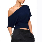 Navy blue one-shoulder top worn by a model on a white background