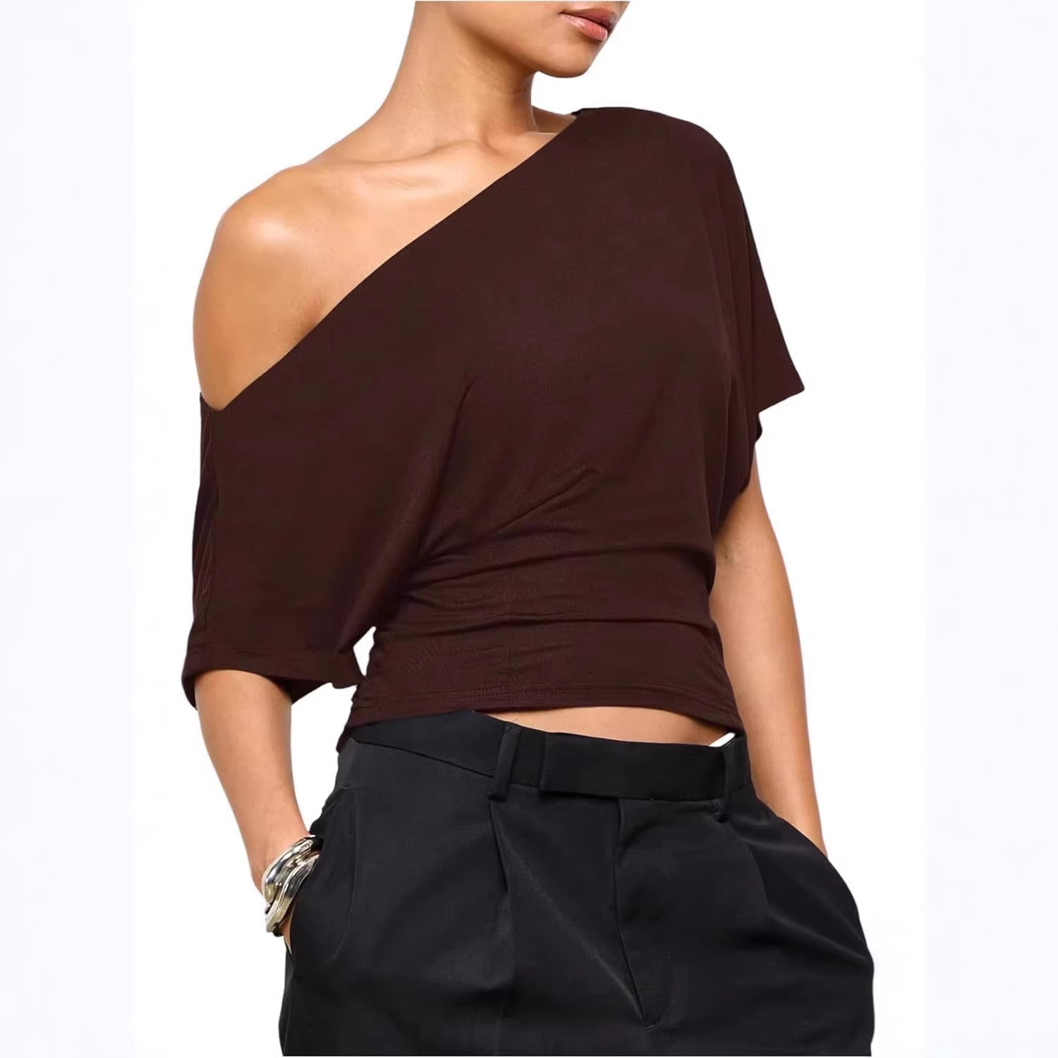 Brown one-shoulder top worn by a model on a white background