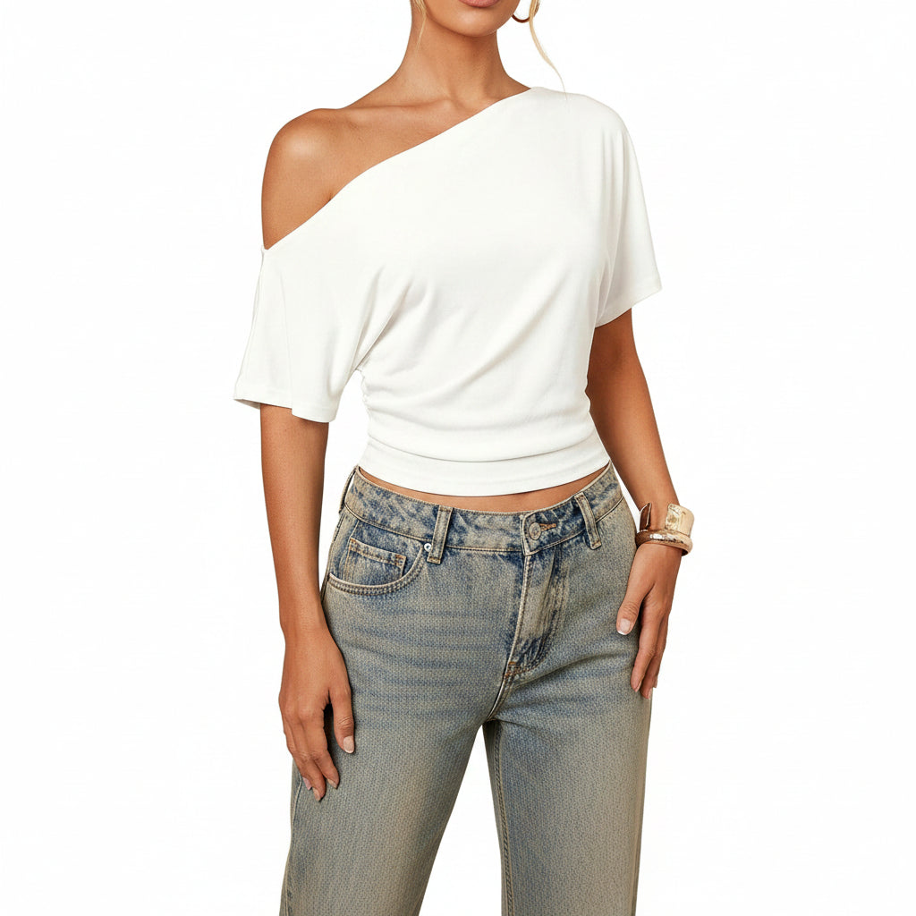White one-shoulder top worn by a person on a white background