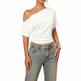 White one-shoulder top worn by a person on a white background