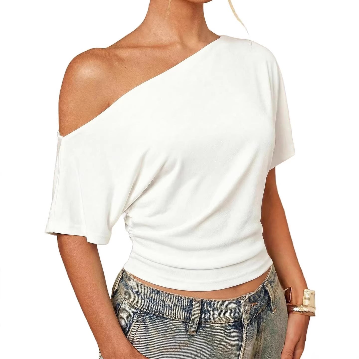 White one-shoulder top worn by a person on a white background