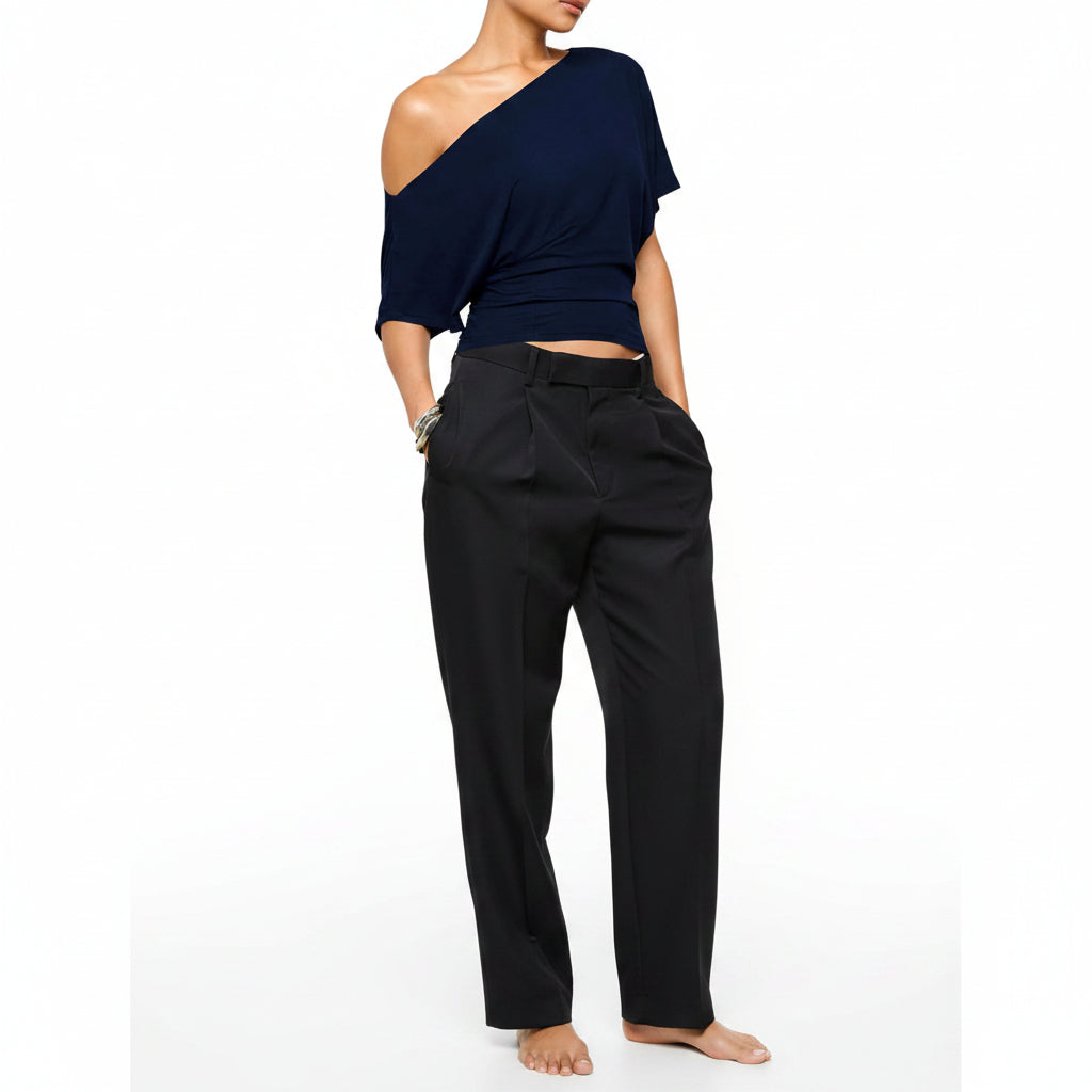 Navy blue one-shoulder top worn by a model on a white background