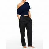 Navy blue one-shoulder top worn by a model on a white background