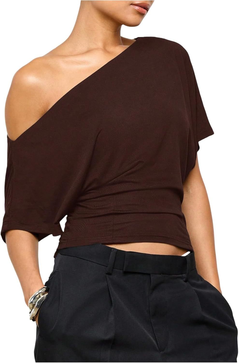 Brown one-shoulder top worn by a model on a white background