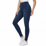 Person wearing blue jeans and white sneakers on a white background