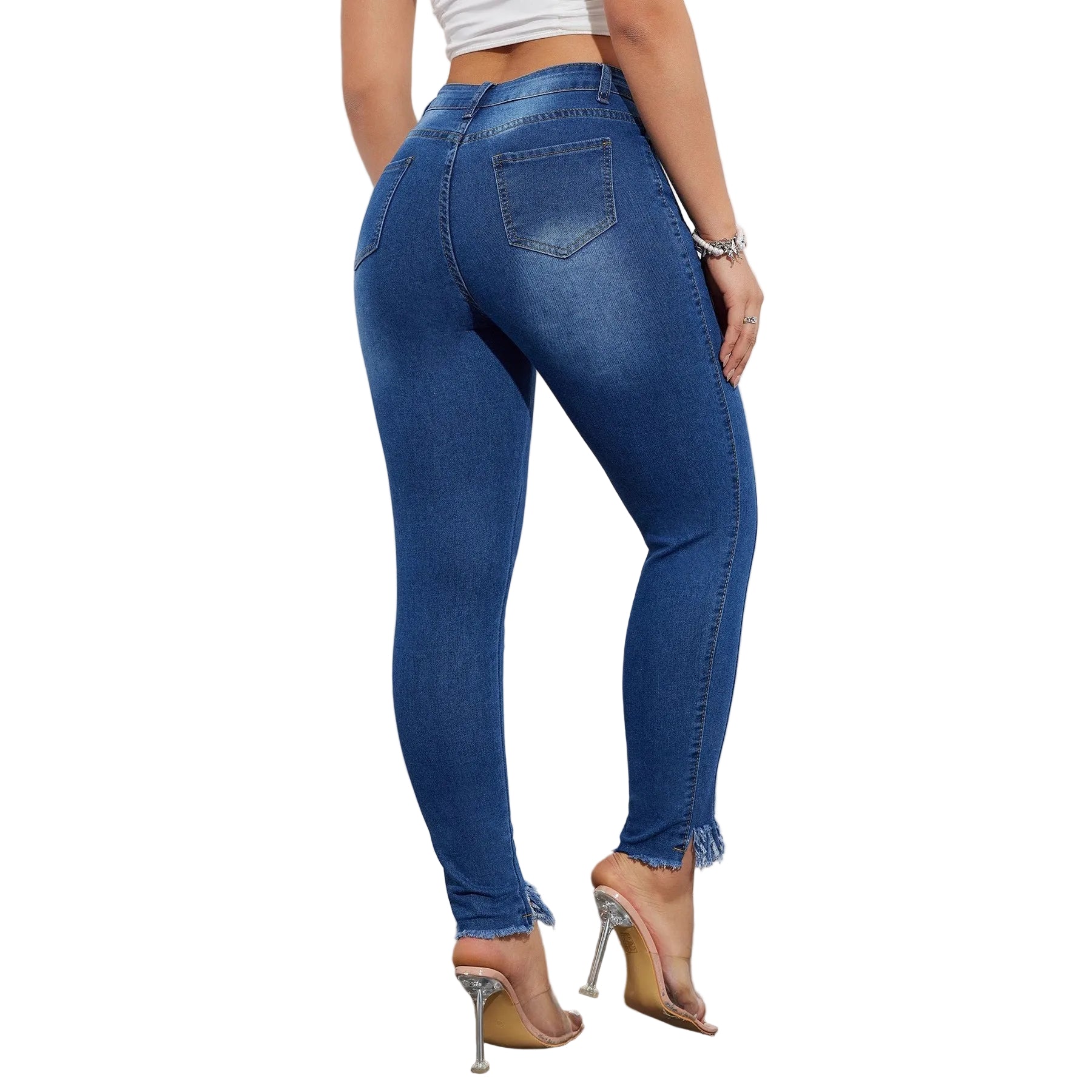 Person wearing blue jeans and high-heeled shoes on a plain background
