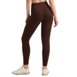 Brown leggings worn by a person on a gray background