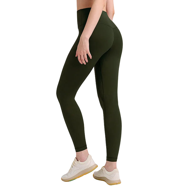 Person wearing dark green leggings on a light gray background