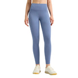 Person wearing blue leggings on a gray background