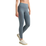 Person wearing gray leggings on a plain background
