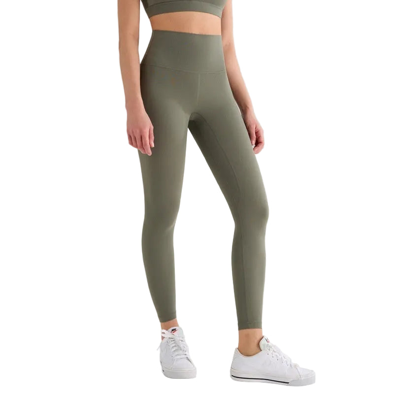 Person wearing olive green leggings with a white background and 'T-Line Sports Edition' label.