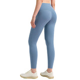 Person wearing blue leggings on a gray background