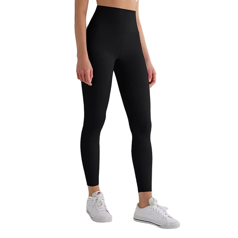 Person wearing black leggings with a white background