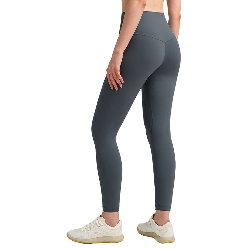 Person wearing gray leggings on a plain background