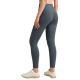 Person wearing gray leggings on a plain background