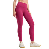 Person wearing bright pink leggings on a gray background