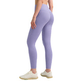 Person wearing lavender leggings with a plain background