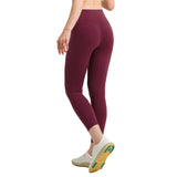 Maroon leggings worn by a person on a gray background
