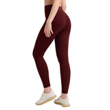 Maroon leggings worn by a person on a plain background