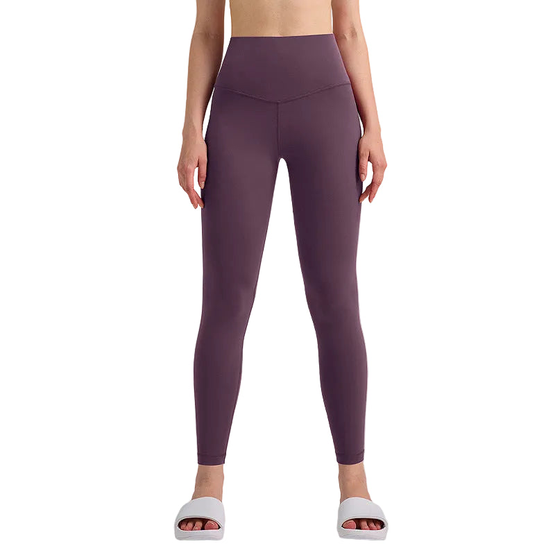 Person wearing purple leggings on a gray background