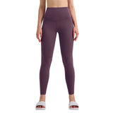 Person wearing purple leggings on a gray background
