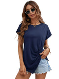 Woman wearing a navy blue t-shirt and denim shorts against a white background