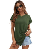 Woman wearing an olive green t-shirt and denim shorts against a white background